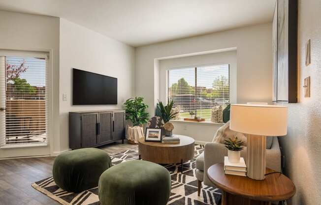 a living room with green chairs and a television