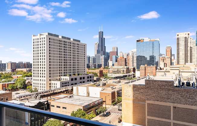 a view of the city from a balcony on a sunny day at One 333, Chicago, IL, 60605