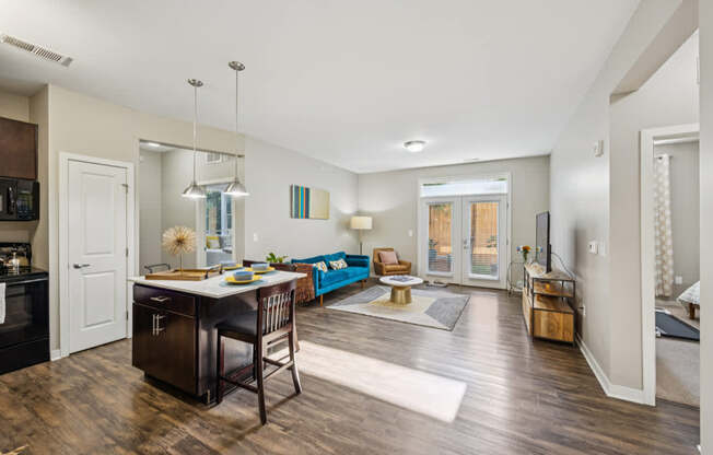 A kitchen with a dining table and chairs.