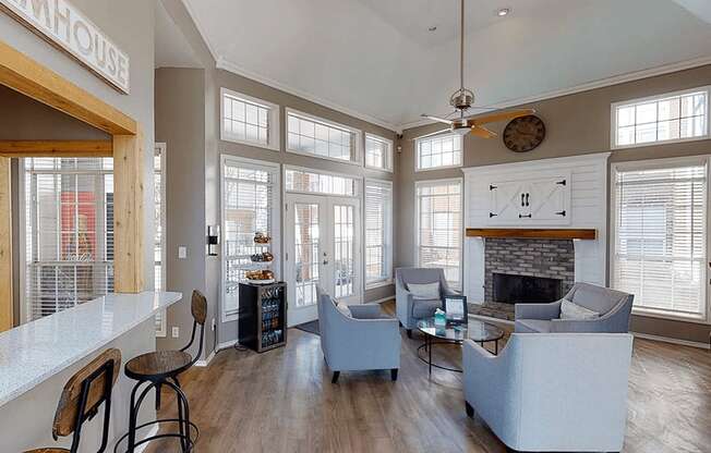 a living room with large windows and a fireplace