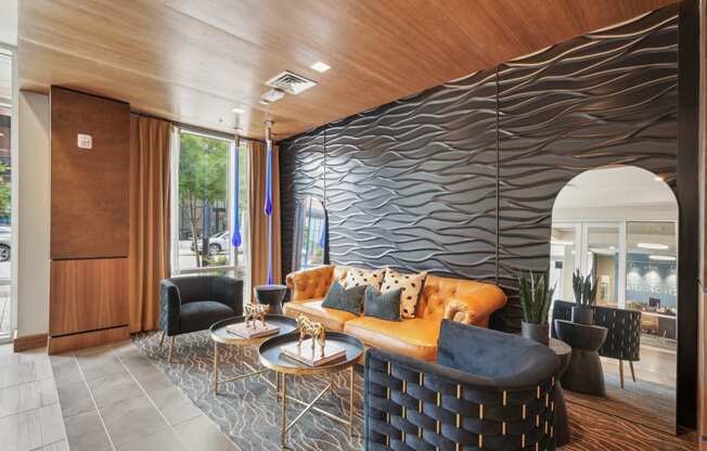 the lobby of a hotel with a couch and tables