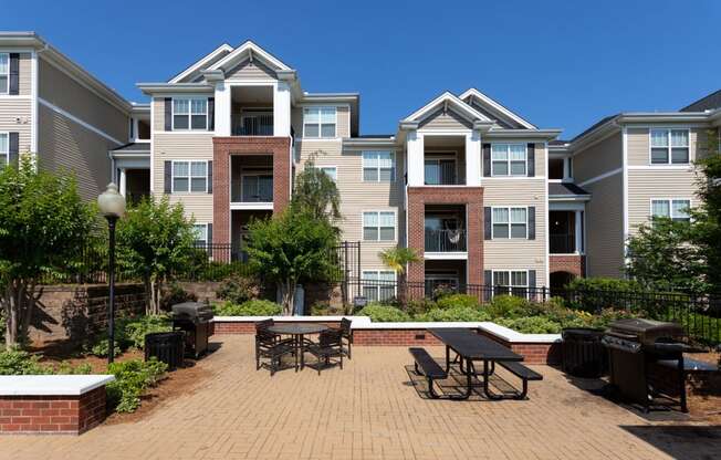Garden Courtyard With Grills And Fireplace at Abberly Village Apartment Homes by HHHunt, South Carolina, 29169
