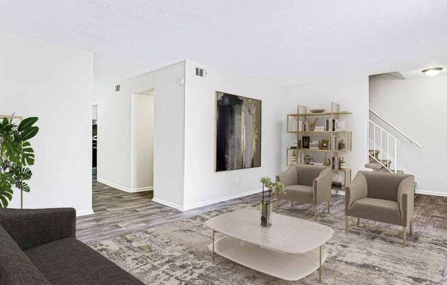 a living room with a couch and chairs and a coffee table at Elea Apartments in Marietta, GA