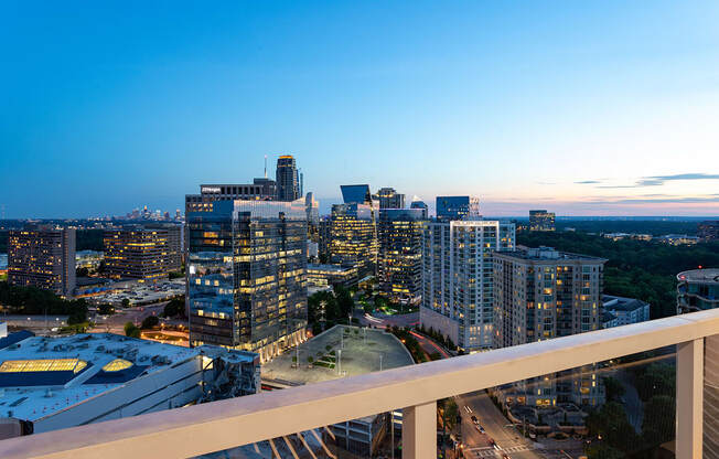 a city skyline at dusk from a high rise building