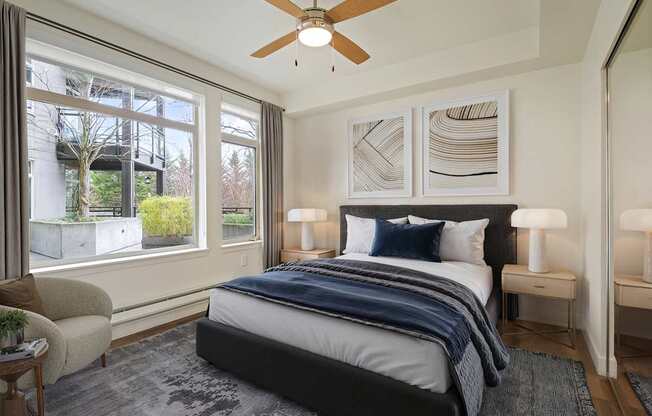 A bedroom with a large bed and a ceiling fan.