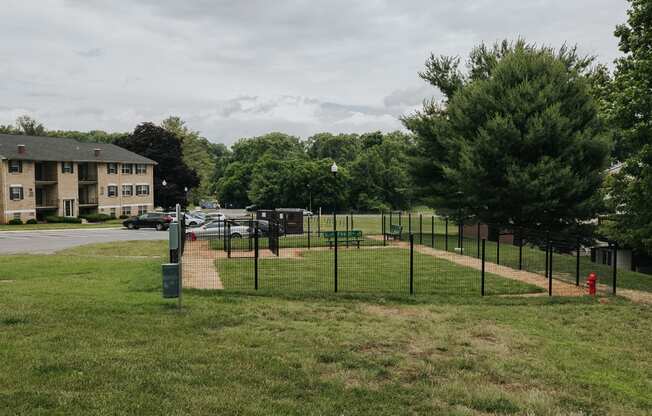 Fenced in Dog Park with benches at Woodridge Apartments in Randallstown, MD 21133.