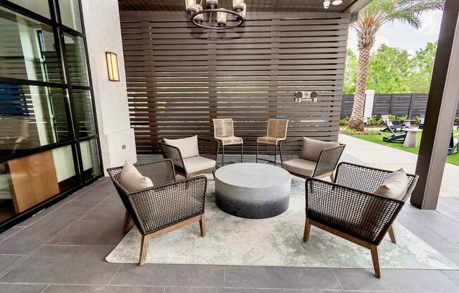 A patio with a table and chairs.