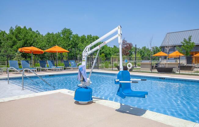 a blue umbrella sitting next to a pool of water