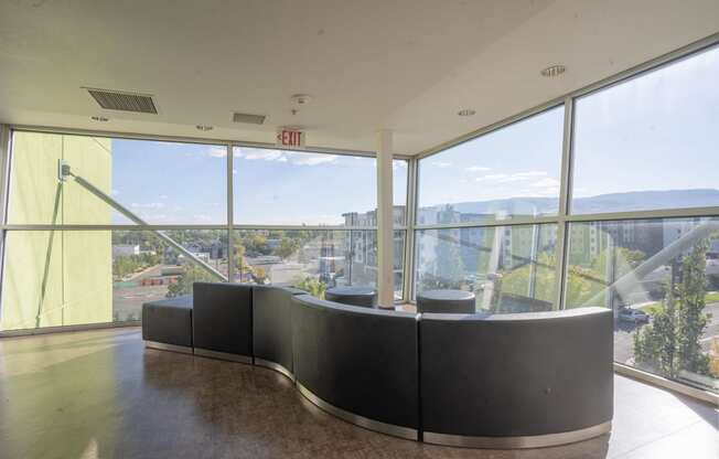 a seating area in a building with a view of the city