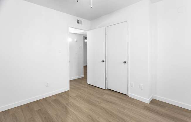 an empty room with white walls and white doors