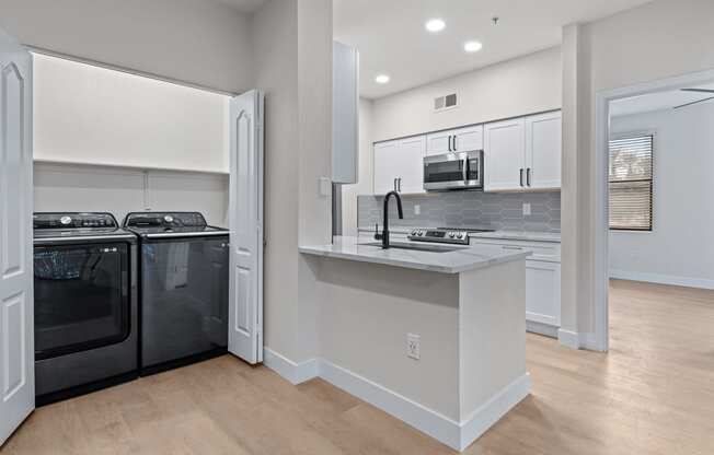 a kitchen with white cabinets and a white counter top