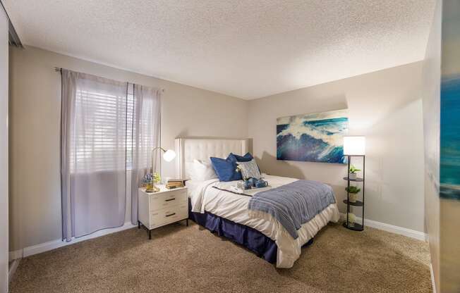 Bedroom with a bed and a window at 2900 Lux Apartment Homes, Nevada