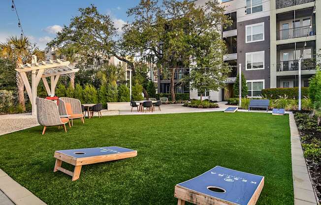 an apartment yard with a ping pong table and chairs