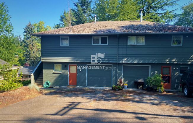 Spacious Multnomah Village Duplex sits amongst a treetop setting. Fenced Backyard. Landscaping Included!