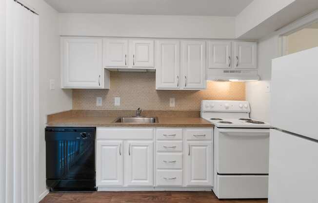 This is a photo of kitchen in the 751 square foot 1 bedroom, 1 bath apartment with fireplace at Woodbridge Apartments in Dallas, TX.