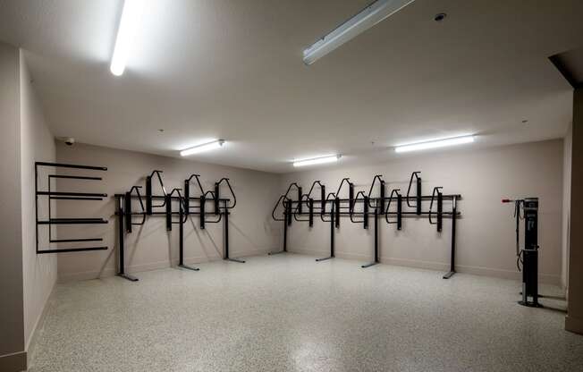 a workout room with weights on racks in the corner of a room