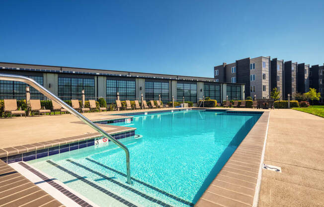 a swimming pool with a building in the background