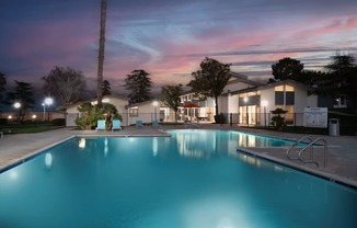 A swimming pool at a residential area during twilight.