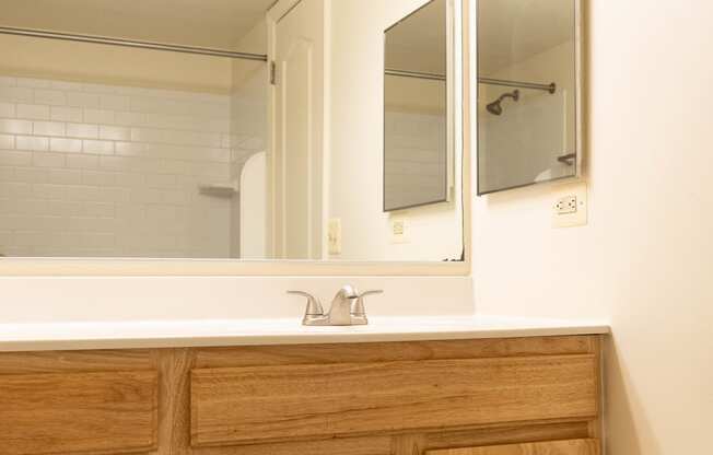a bathroom with a sink and a mirror at Charlesgate Apartments, Towson