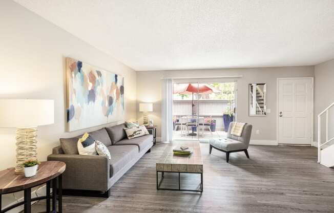 a living room with a couch chair and coffee table