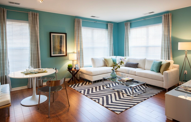 Bright and Expansive Living Room With Wood-Style Flooring (Available in Select Apartments)