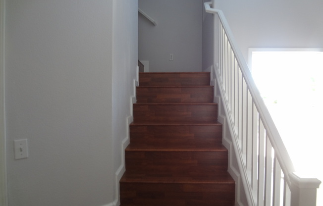 THIS 1,596 SQ. FT. HOME HAS 3 BEDROOMS, 2.5 BATHROOMS, A 2 CAR GARAGE LOCATED ON A CORNER LOT AND NEW WOOD FLOORING