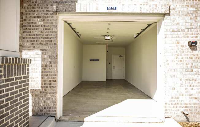 the entrance to a building with a long hallway with a white door