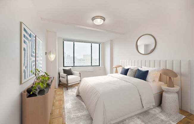 A bedroom with a large bed and a window overlooking the city.