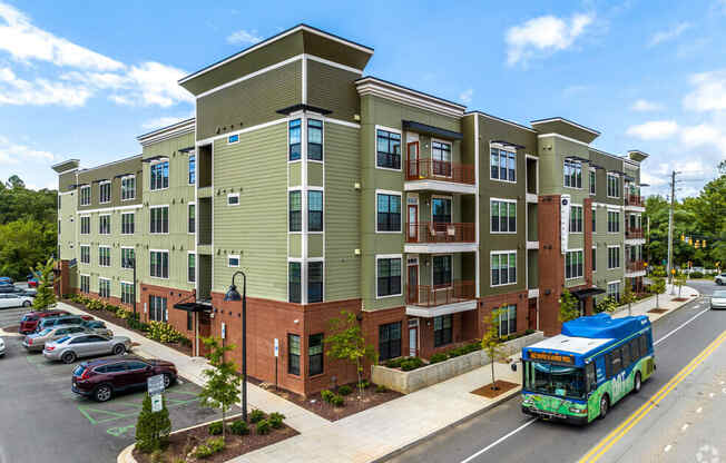 a bus is parked in front of an apartment building