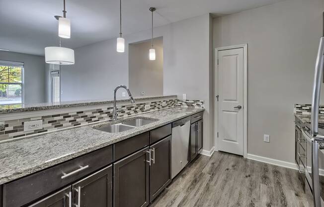 a kitchen with granite counter tops and stainless steel appliances at Nexus at Sandhill, Columbia