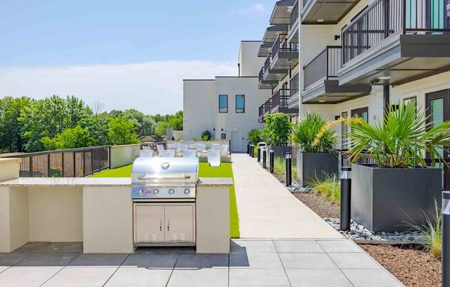 A modern outdoor kitchen with a grill and sink.