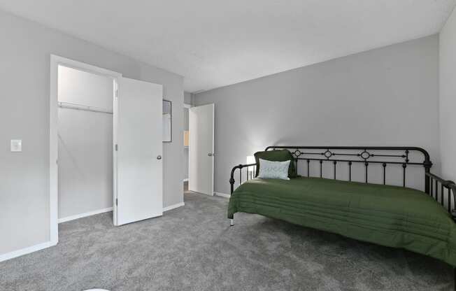 an empty bedroom with a bed and a closet