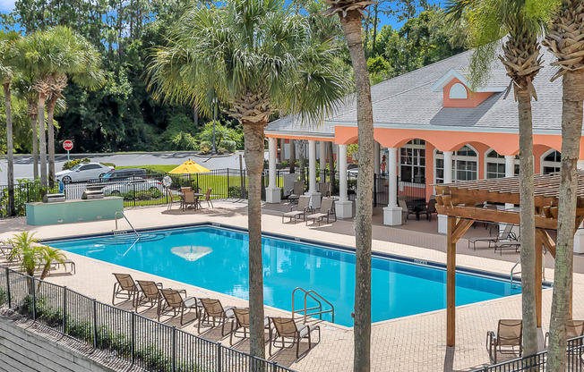Large resort-style pool and covered patio at Bermuda Estates Apartments in Ormond Beach, FL