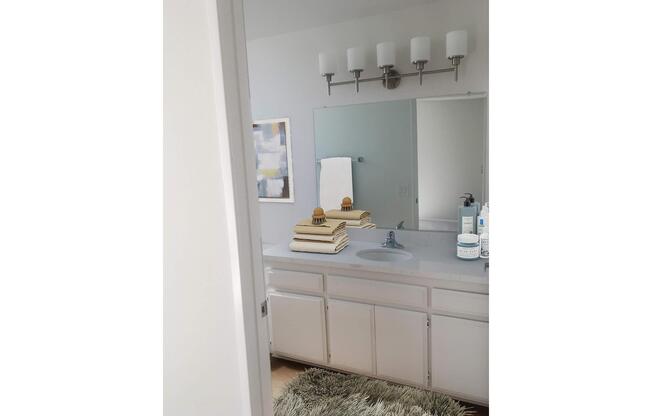 a kitchen with a sink and a mirror