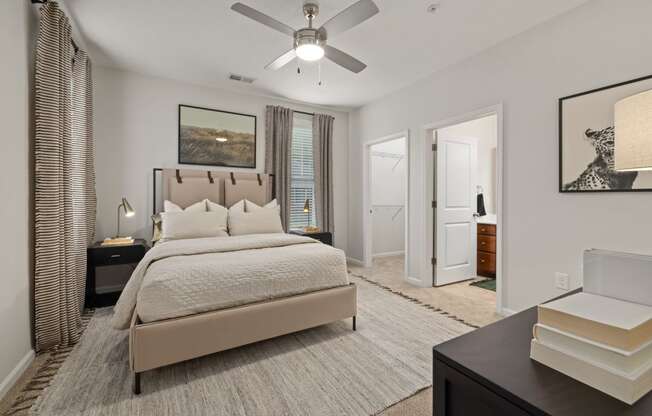 a bedroom with a bed and a ceiling fan