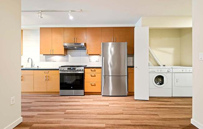 A kitchen with wooden cabinets and stainless steel appliances.
