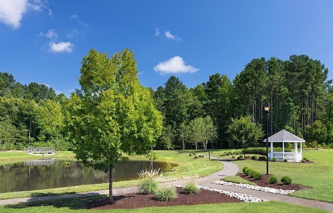 a park with a pond and gazebo