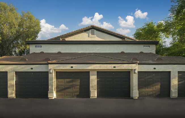a row of garage doors in front of a house