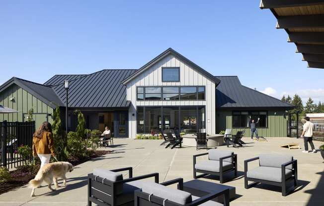 a dog walking on a patio in front of a building