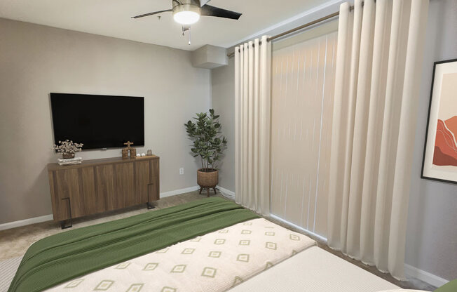 a bedroom with a bed and a tv