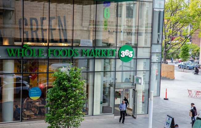 the front of a whole foods market store on a city street at The Paxton, New york