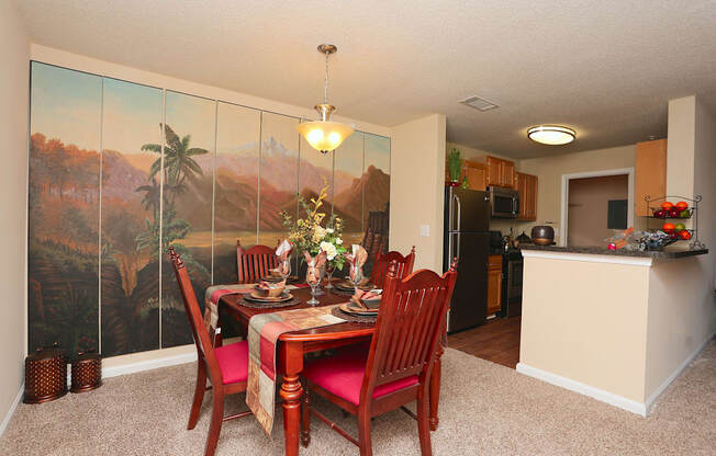 a dining room with a table and chairs and a kitchen