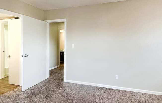 A room with a carpeted floor and white walls.