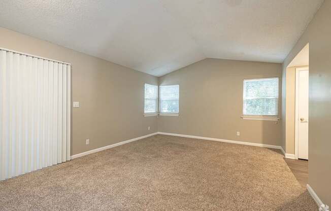 A room with a carpeted floor and a slanted ceiling.
