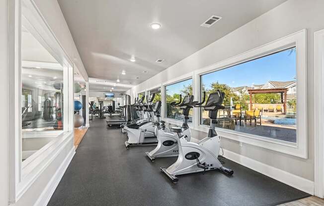 A gym with treadmills and exercise bikes.