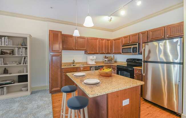 a kitchen with stainless steel appliances and a granite counter top