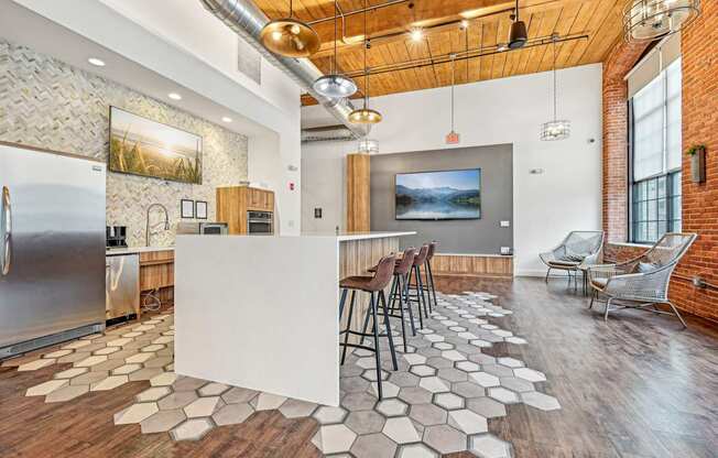 a kitchen with a white island and bar stools