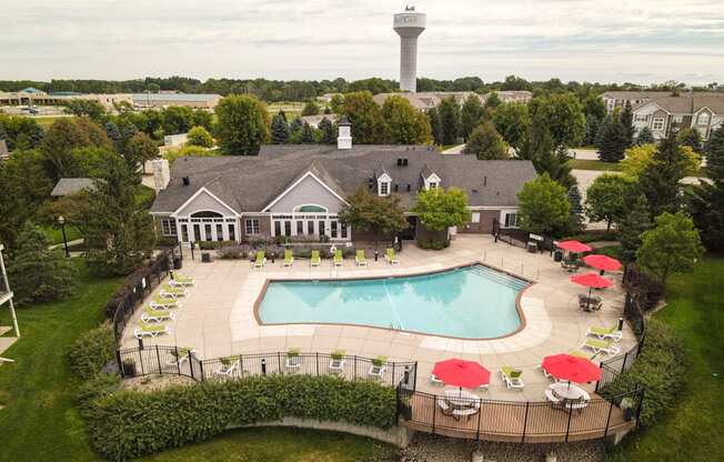 A large building with a pool in front of it.