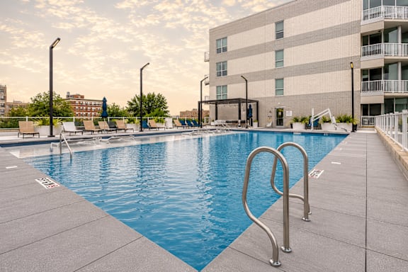 A swimming pool with a metal ladder in the middle of it.