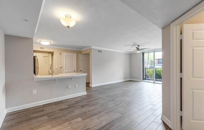 A room with a wooden floor and a ceiling fan.